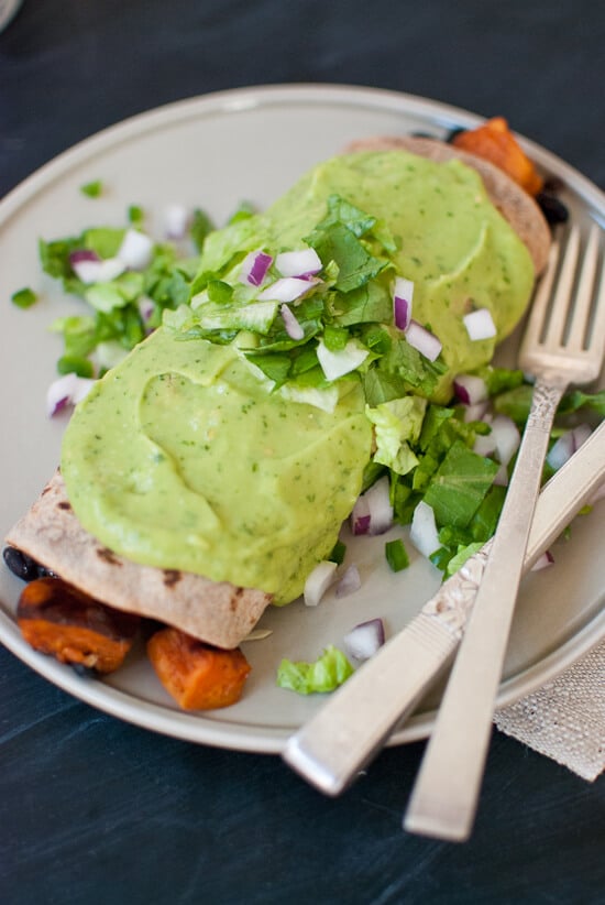Sweet potato burrito smothered with avocado salsa verde