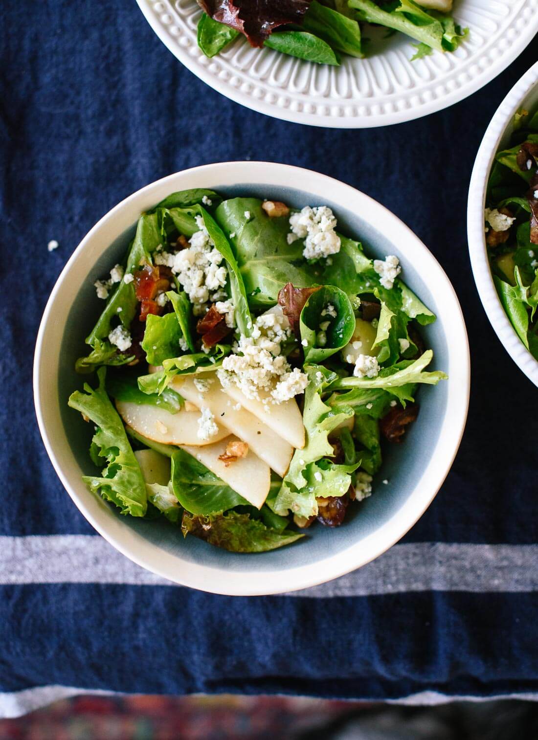 This fresh green salad with pears, walnuts, dates and blue cheese is a fresh option for your holiday table! cookieandkate.com