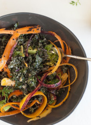 raw kale salad with tahini dressing, carrots and avocado