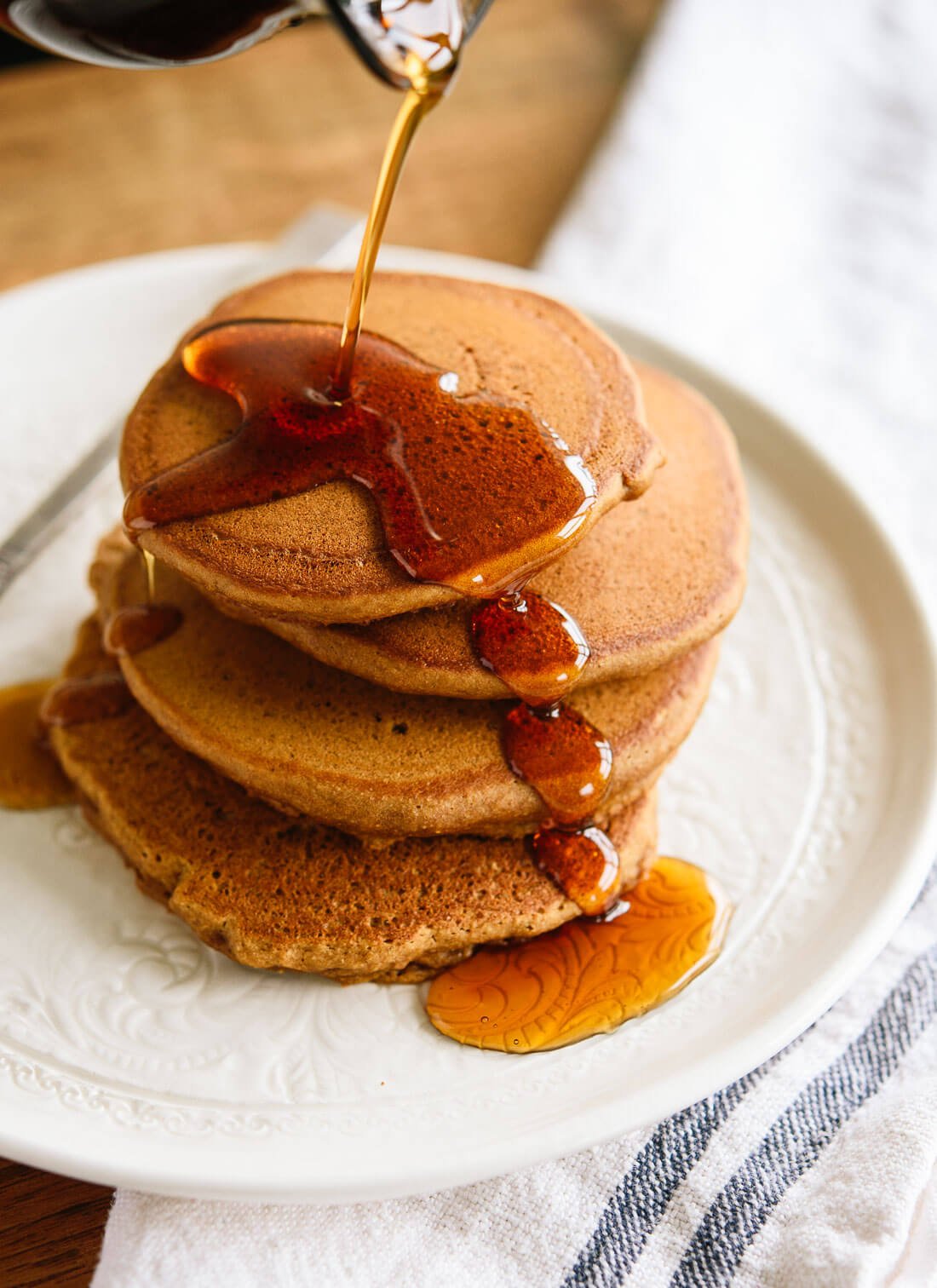 These whole wheat gingerbread pancakes are light, fluffy and delicious! Perfect for Christmas mornings and cold days. cookieandkate.com