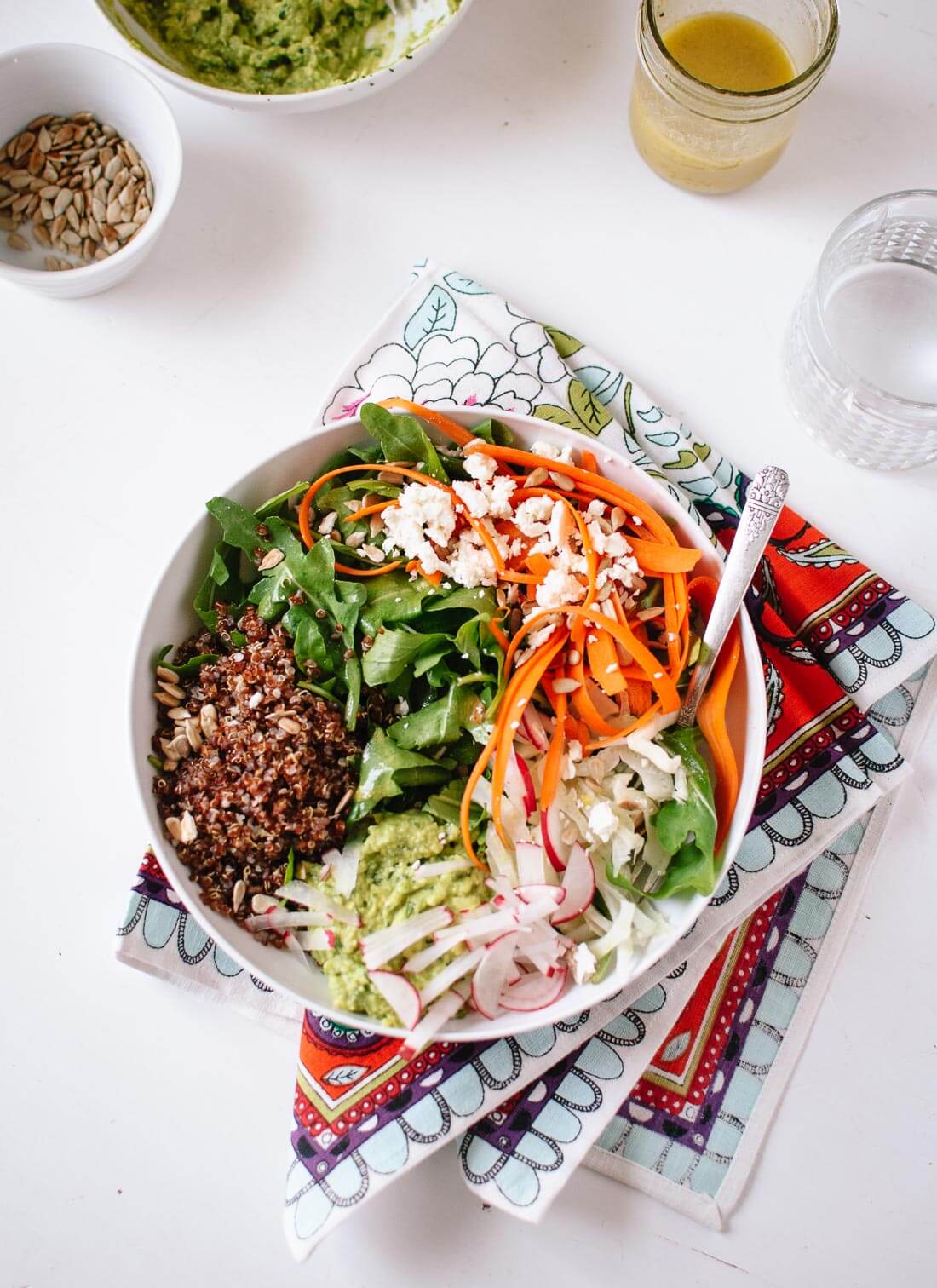This delicious and hearty salad features arugula, carrots, quinoa and avocado - cookieandkate.com