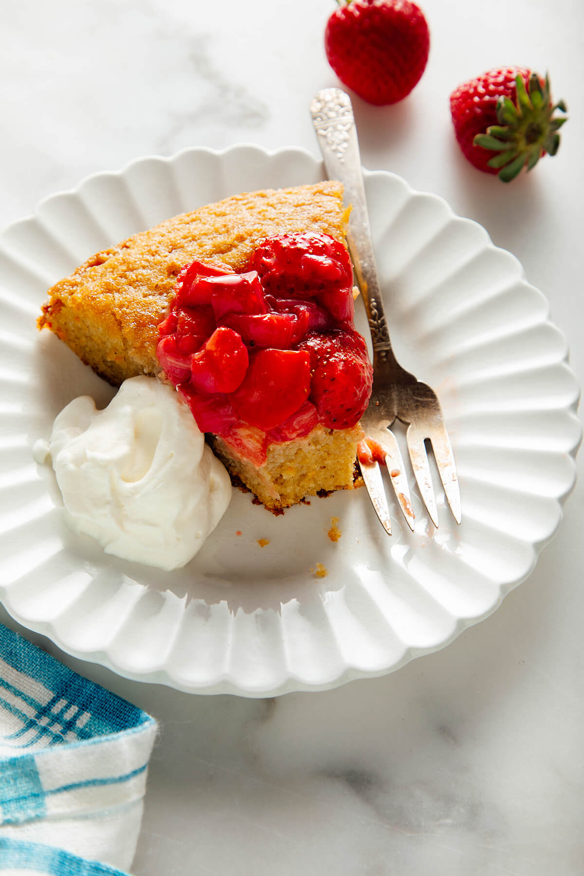 slice of almond cake topped with strawberries and rhubarb