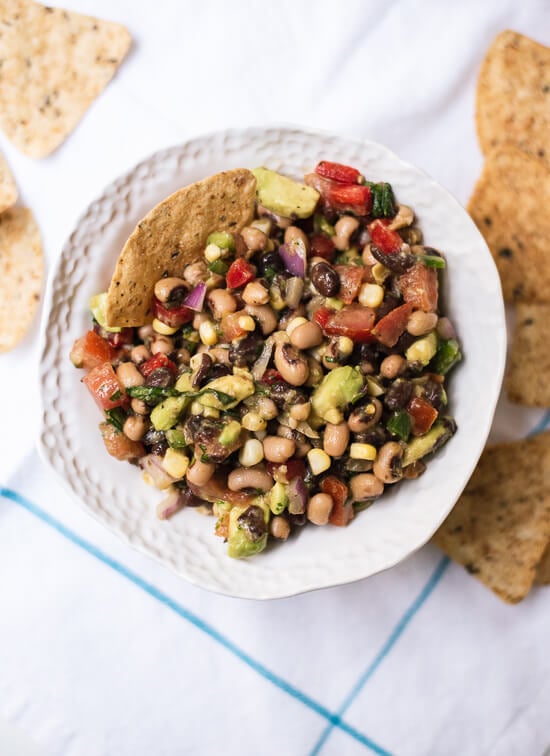 Cowboy caviar dip (a popular Southern bean salsa) is always a hit at summer potlucks! It's healthy, too. cookieandkate.com