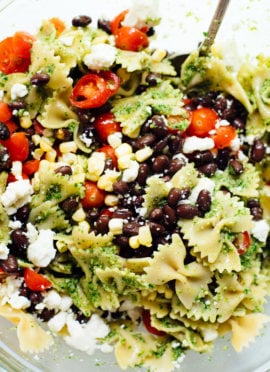 Healthy summertime pasta salad, made with jalapeño-cilantro pesto, cherry tomatoes, corn, black beans and feta. You'll love this surprising combination!