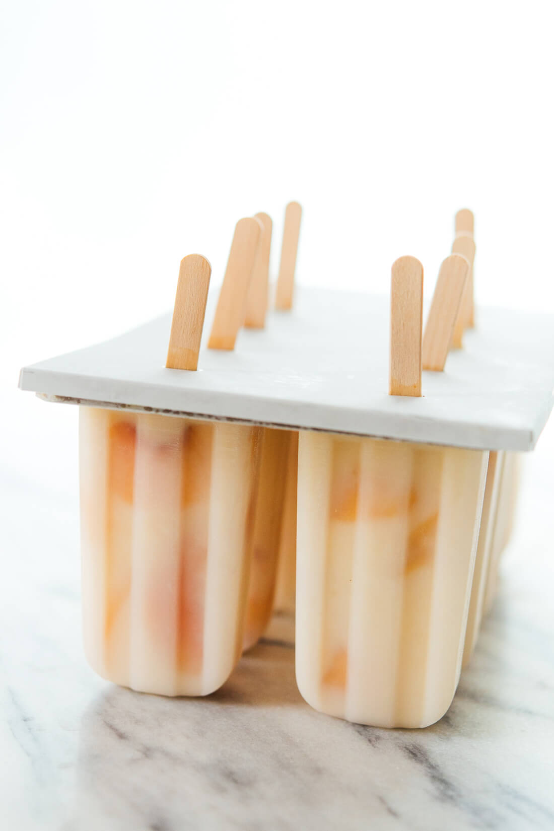 Creamy honey-sweetened peach yogurt popsicles