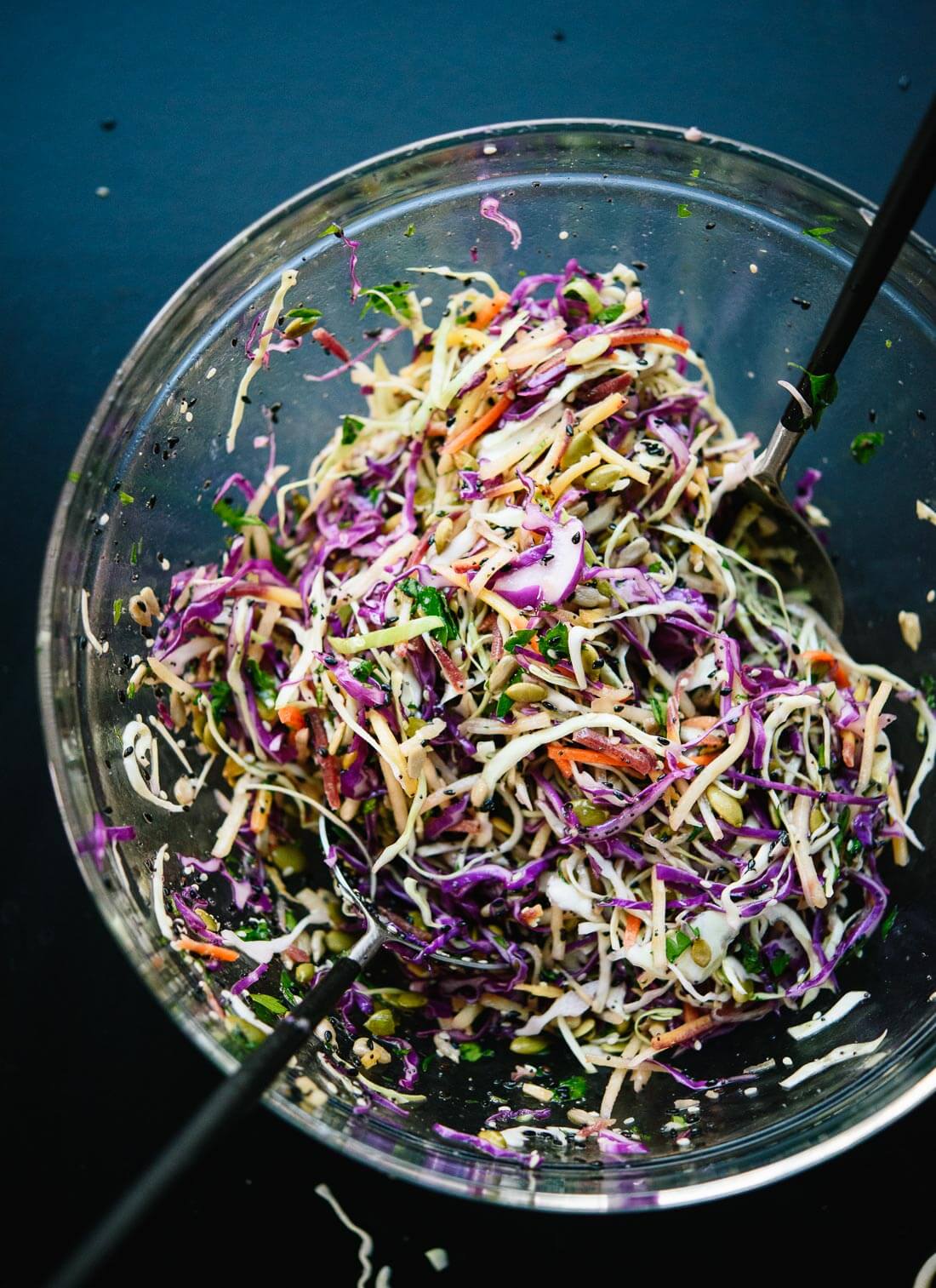 This healthy slaw recipe tastes amazing! It's made with a simple lemon dressing and features toasted sunflower and pumpkin seeds. Gluten free and vegan. - cookieandkate.com