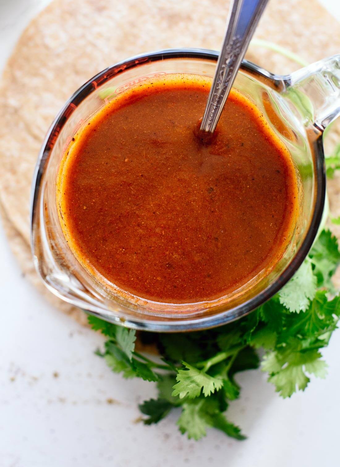 Homemade enchilada sauce is so easy to make! This sauce tastes so good, you'll never go back to the store-bought kind. Perfect for your other Mexican recipes, too! cookieandkate.com