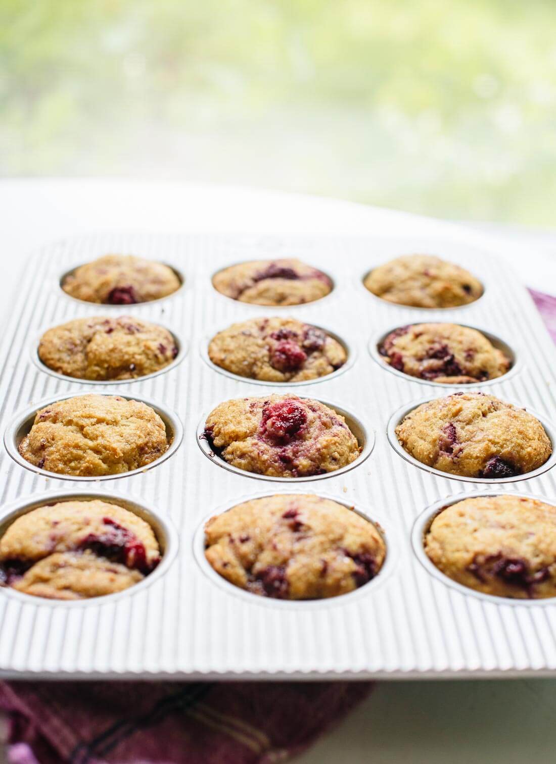 These delicious lemon raspberry muffins are so easy to make with frozen raspberries! cookieandkate.com