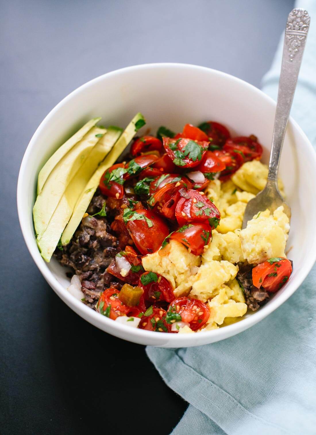 This hearty breakfast bowl features Tex-Mex flavors, including pico de gallo, avocado and black beans - cookieandkate.com
