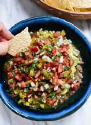 This seven-layer dip features layers of freshly prepared "refried" black beans, guacamole, salsa and pico de gallo! cookieandkate.com