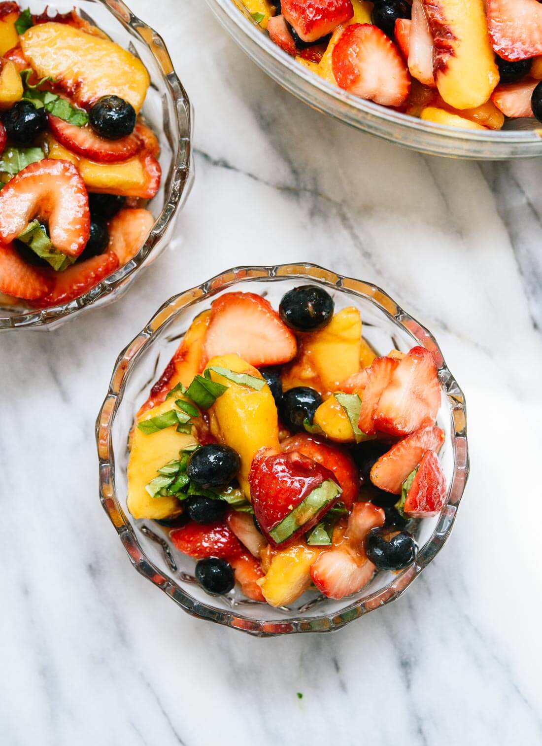 Ripe peaches, strawberries and blueberries collide with a little balsamic vinegar and basil in this amazing fruity side or dessert. This really is the best fruit salad recipe. cookieandkate.com
