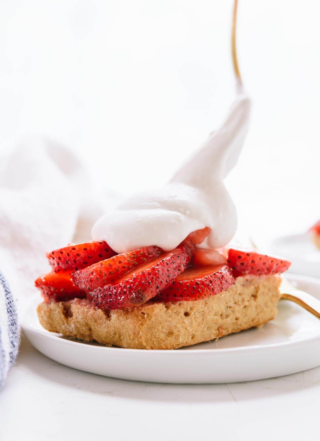 Delicious honey-sweetened strawberry shortcake with coconut whipped cream - cookieandkate.com