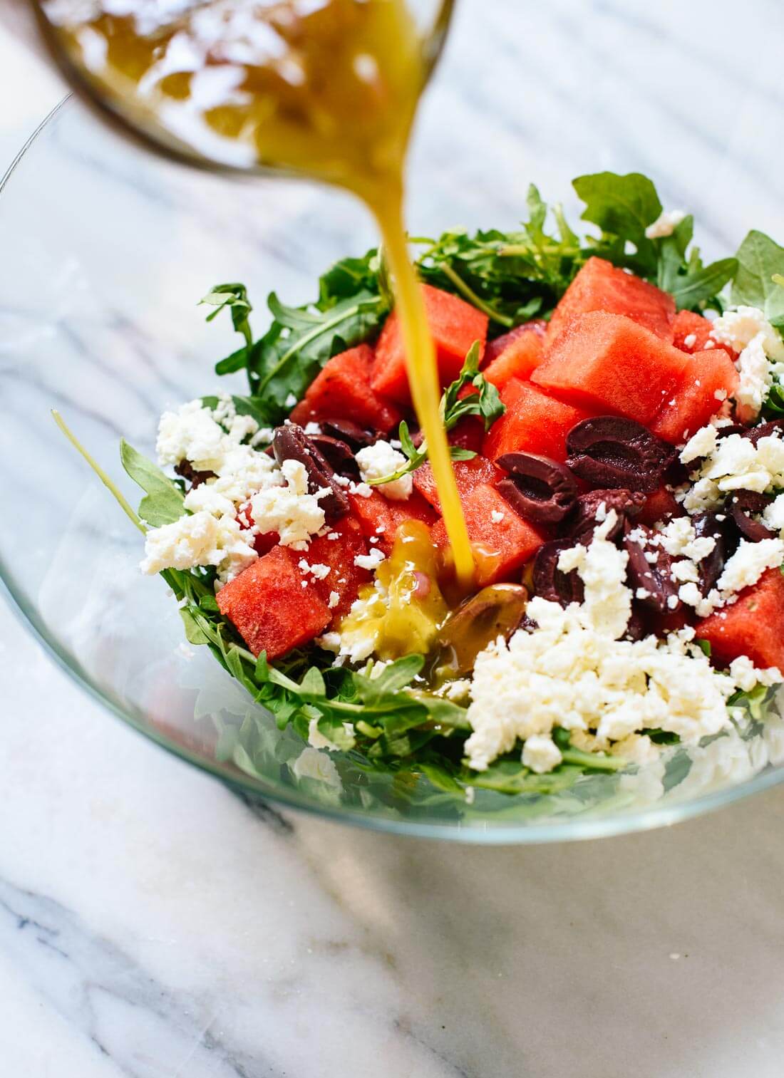 Delicious watermelon salad recipe featuring fresh arugula, feta, and olives with sherry vinaigrette - cookieandkate.com