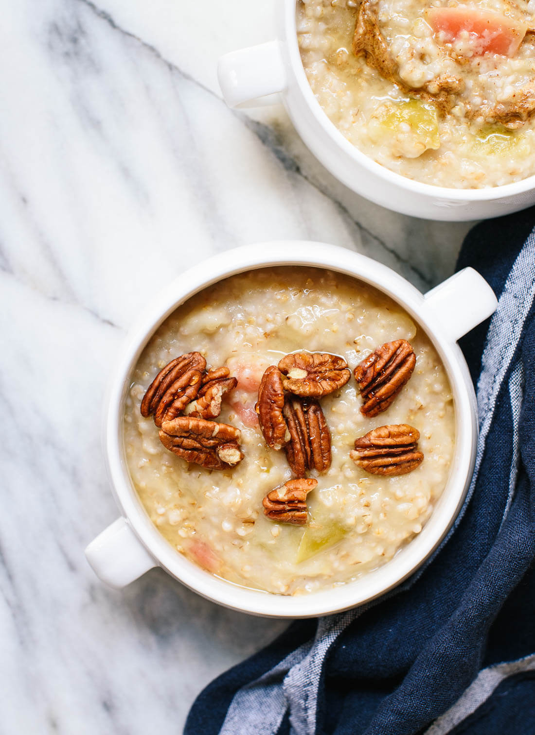 Meet my favorite fall breakfast! Apples and steel-cut oats cook together in the same pot until they are creamy, delicious perfection. It's a hearty and delicious fall breakfast that reheats well for busy weekday mornings! cookieandkate.com