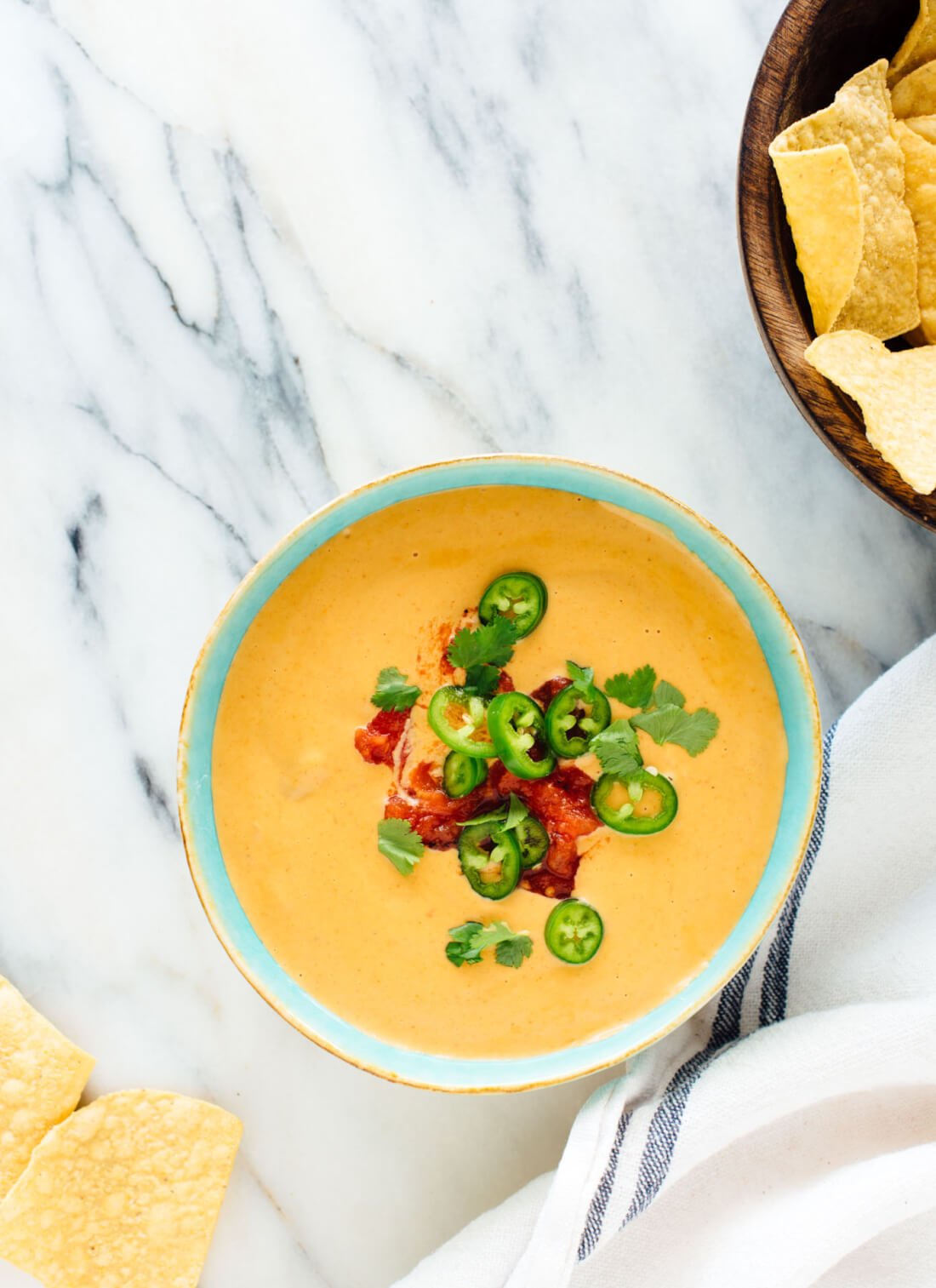 This delicious dairy-free queso recipe is made with cashews and potatoes instead of cheese, but you'd never guess it! cookieandkate.com