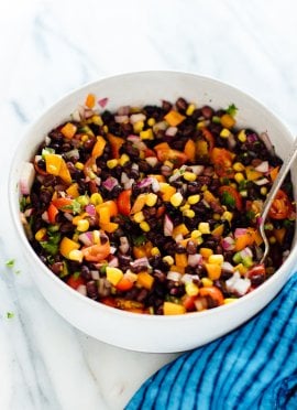 Perfect for parties and busy weeks! This fresh black bean salad recipe is as delicious as it is colorful. It's also vegan and gluten free. cookieandkate.com