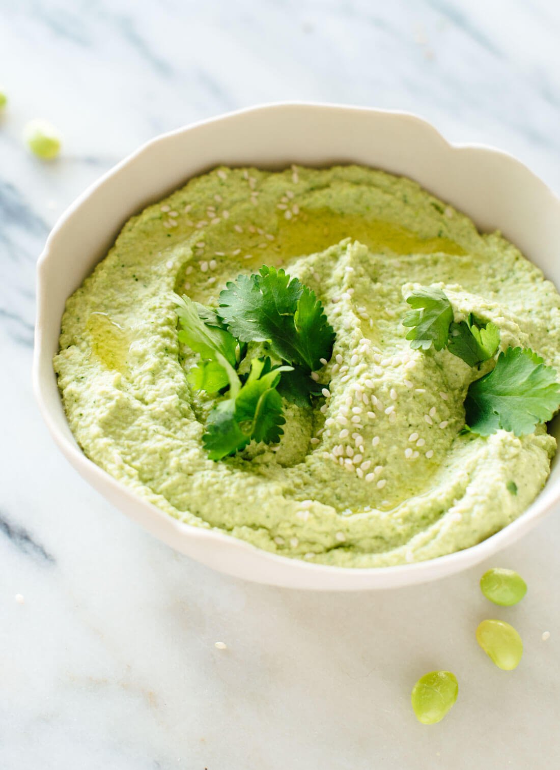 This edamame hummus recipe is fresh, healthy and delicious! It's a fun alternative to regular hummus and pairs well with traditional Mediterranean or Asian flavors. cookieandkate.com