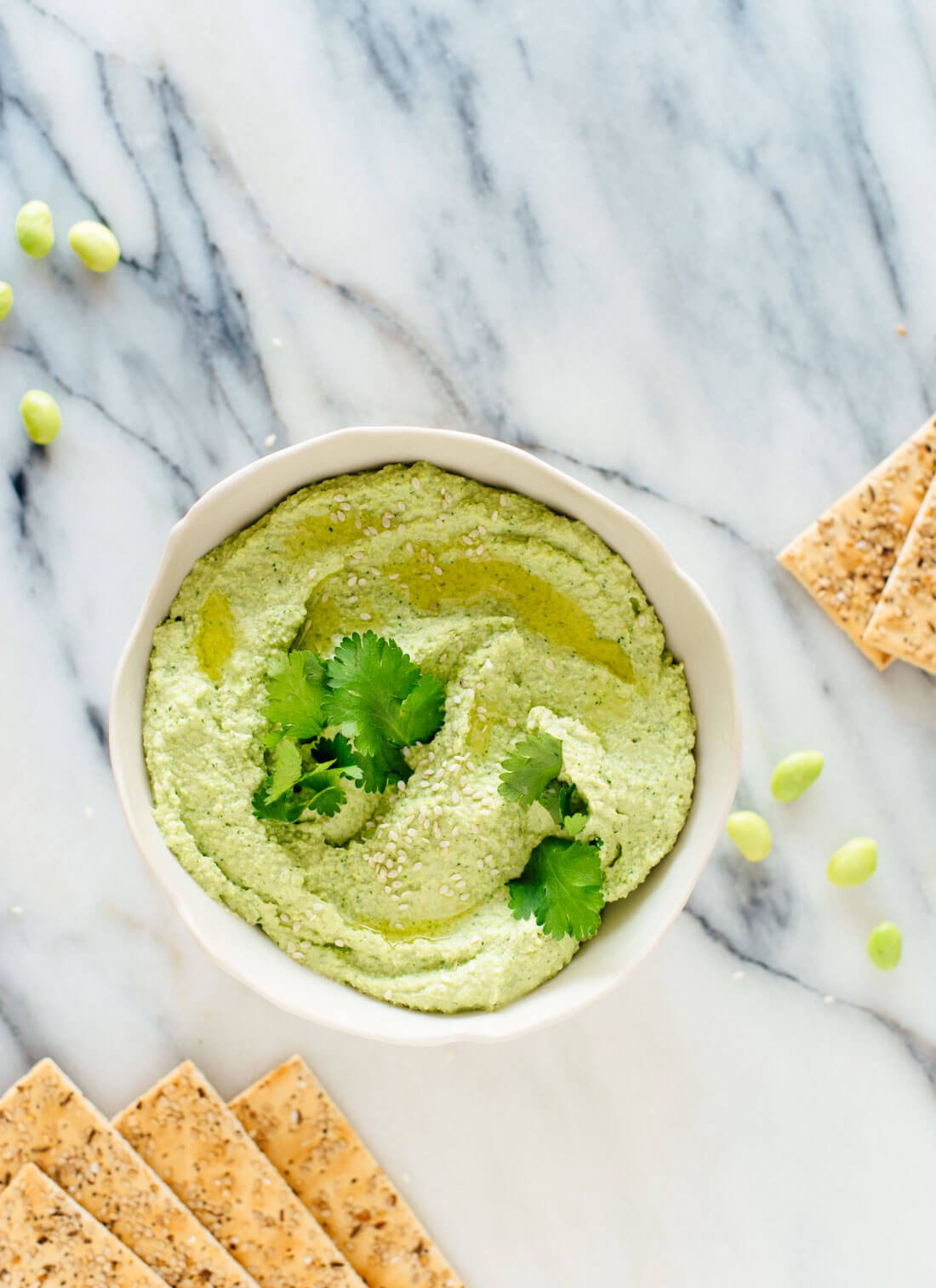 This delicious homemade edamame hummus tastes better than store-bought! This healthy snack happens to be vegan, gluten free and nut free. cookieandkate.com