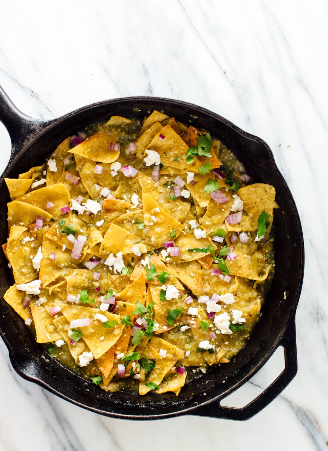 Homemade chilaquiles verdes with baked tortilla chips! Get the recipe at cookieandkate.com