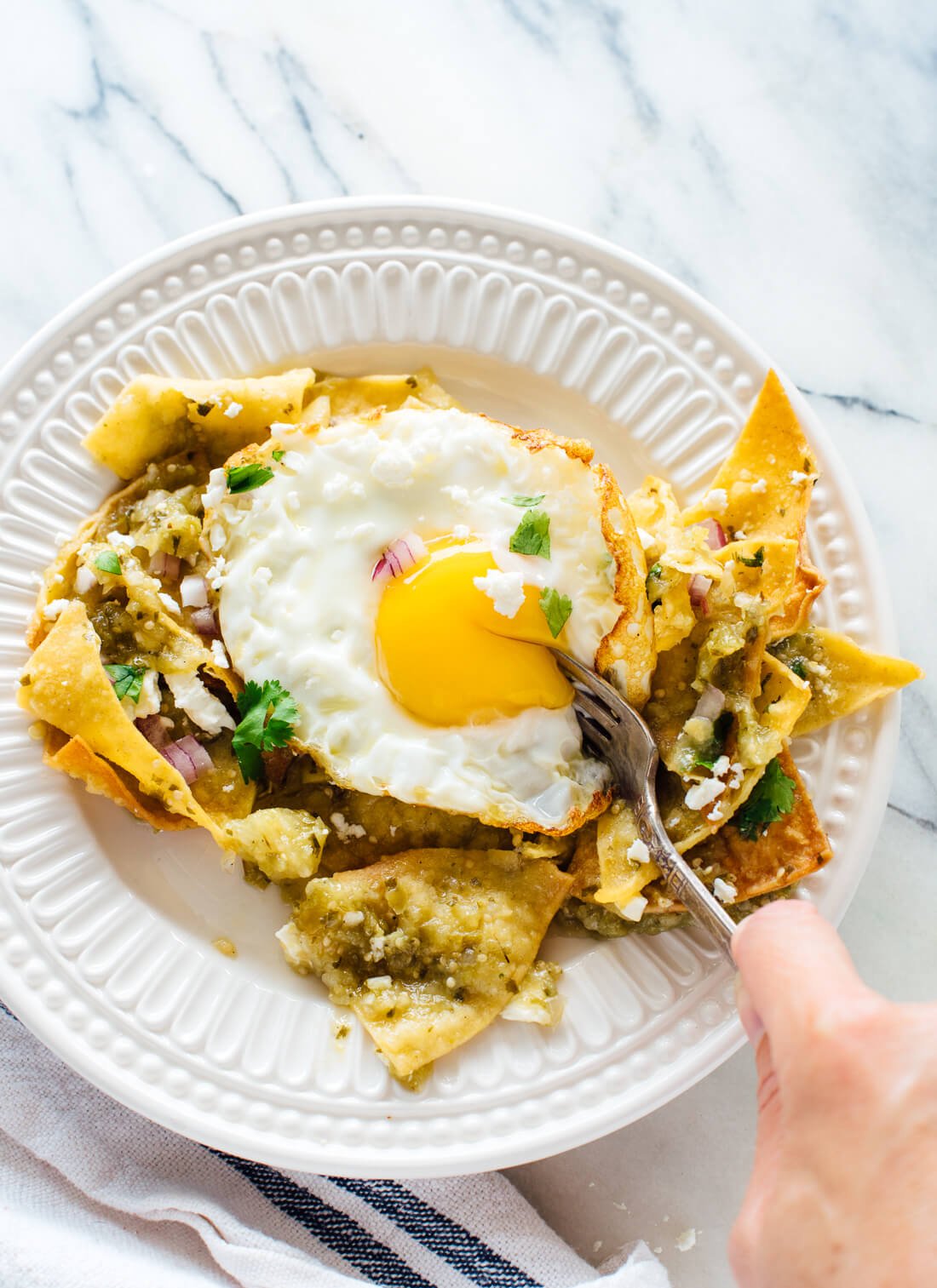 Incredibly delicious chilaquiles verdes with fried eggs, made from scratch! Get this vegetarian recipe at cookieandkate.com