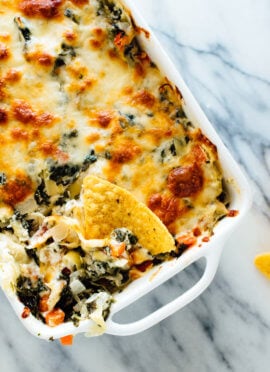 The best cheesy spinach artichoke dip, made lighter with extra veggies and no mayonnaise! Everyone will love this appetizer recipe.