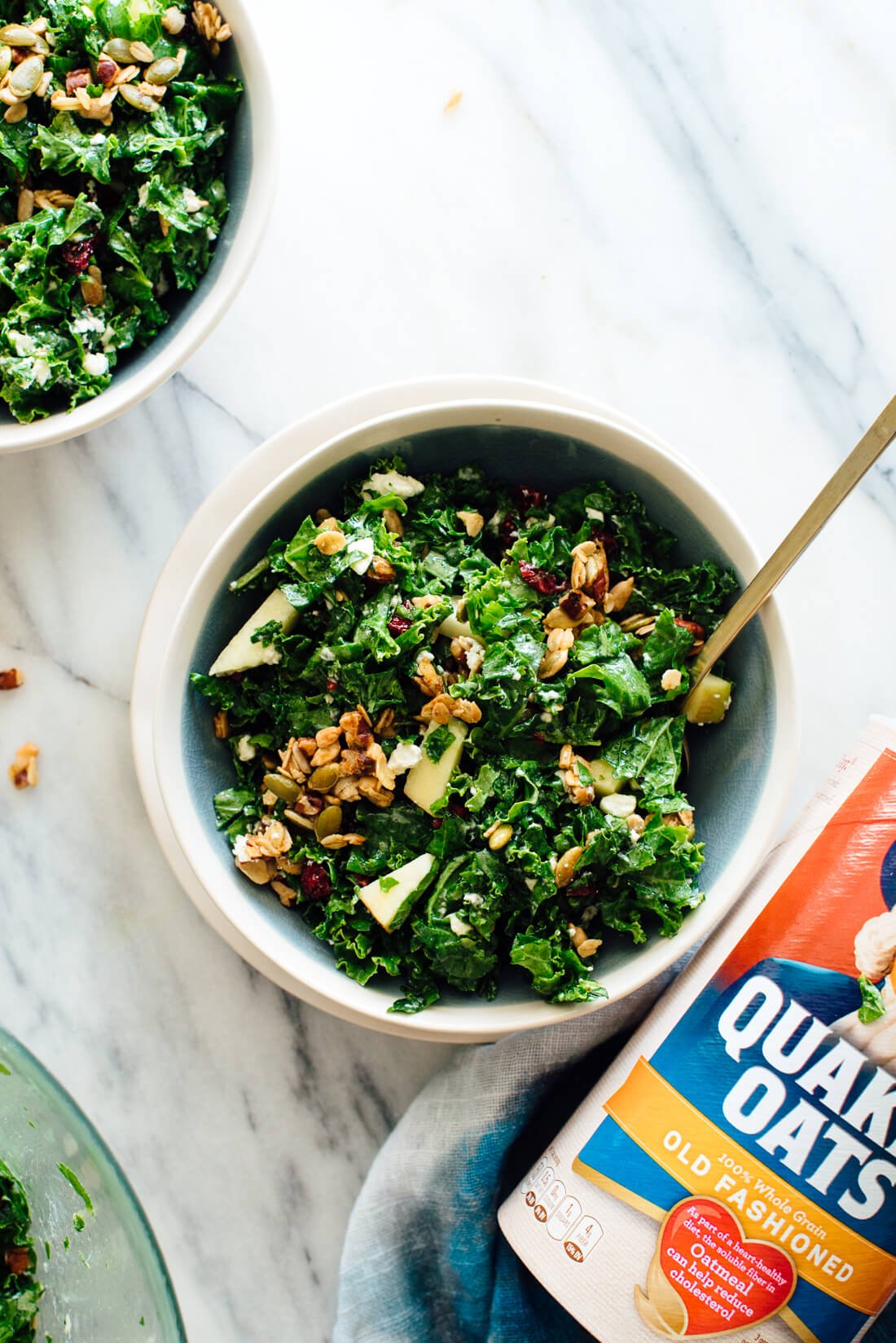 Nutty granola croutons complete this salad made with massaged raw kale, crisp chopped apple, and crumbled goat cheese tossed in a tangy lemon dressing.
