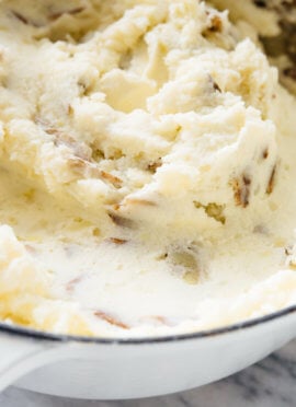 My family's favorite mashed potatoes—they're ultra creamy, a little tangy, and you can make them ahead! #Thanksgiving