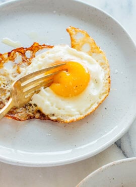 crispy fried egg oozing under fork