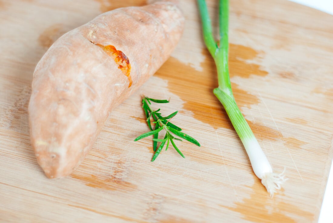 baked sweet potato with fresh rosemary and green onion