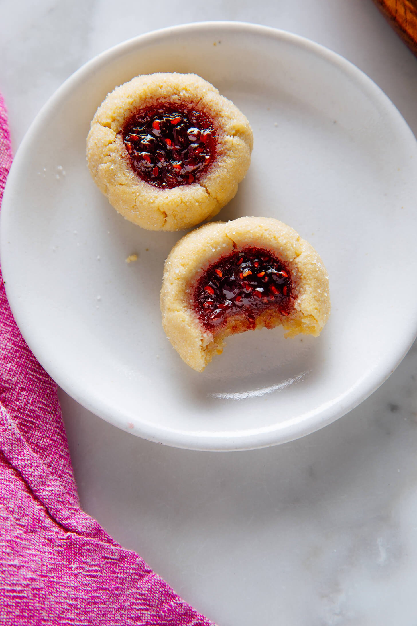 two thumbprint cookies on plate
