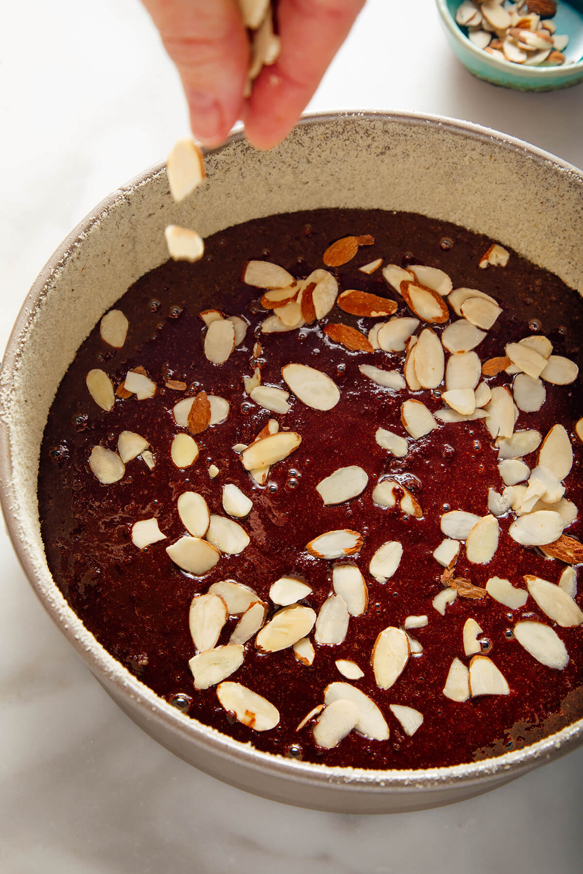 sprinkling sliced almonds on top